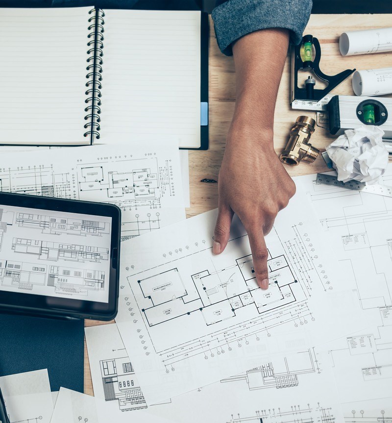 Architect engineer use tablet to read drawing design. House planning design and construction concept.