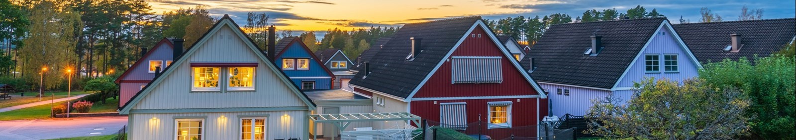 View of traditional Scandinavian timber houses in autumn season at sunset